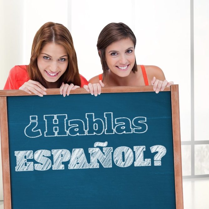 Teenage,Girls,Smiling,While,Holding,A,Blank,Poster,And,Hiding